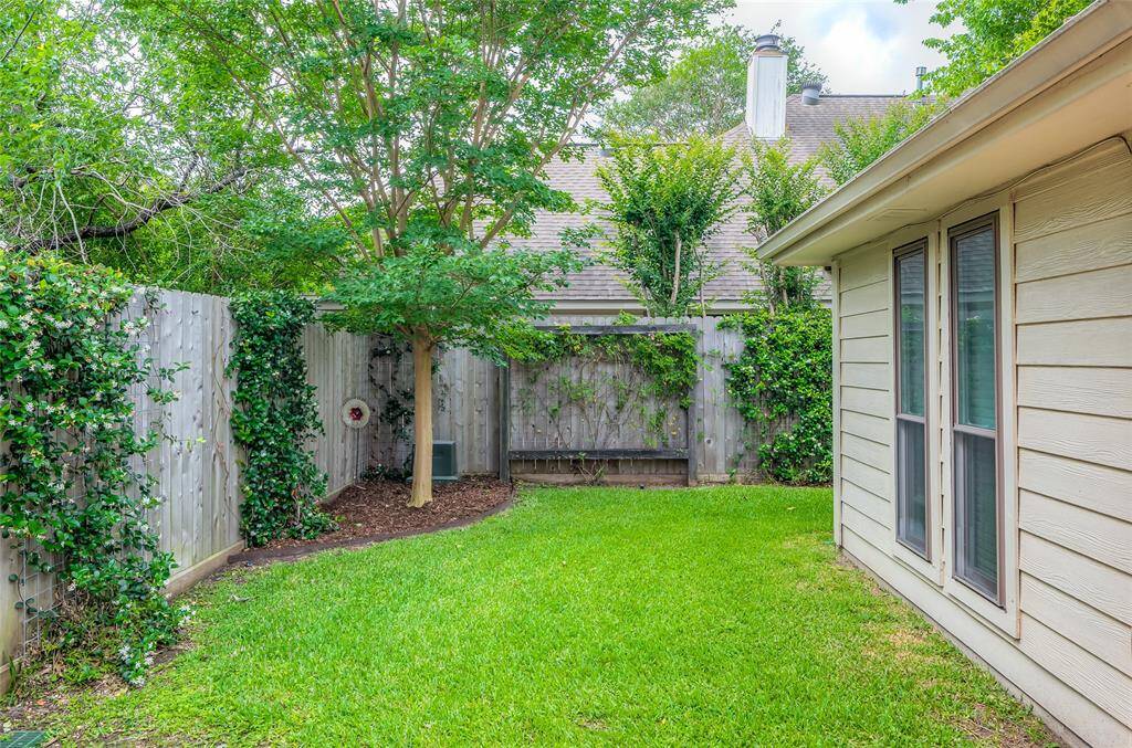 Private fully fenced yard with 3 zone sprinkler system - beautiful roses and fragrant jasmine.