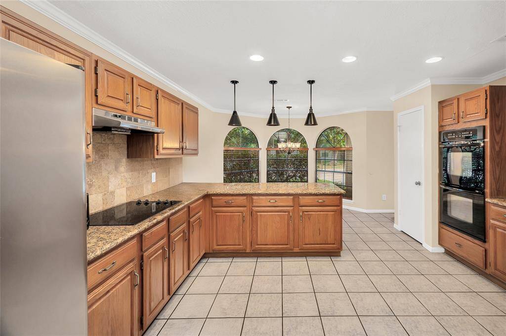 Sunny and bright with double ovens and stainless steel appliances. New chandelier in the breakfast room which is anchored by a large bay window.