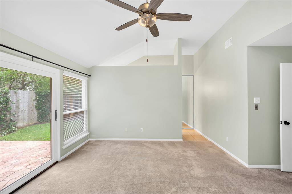 The primary suite is etherial with vaulted ceilings and a view of the yard from floor to ceiling glass doors.