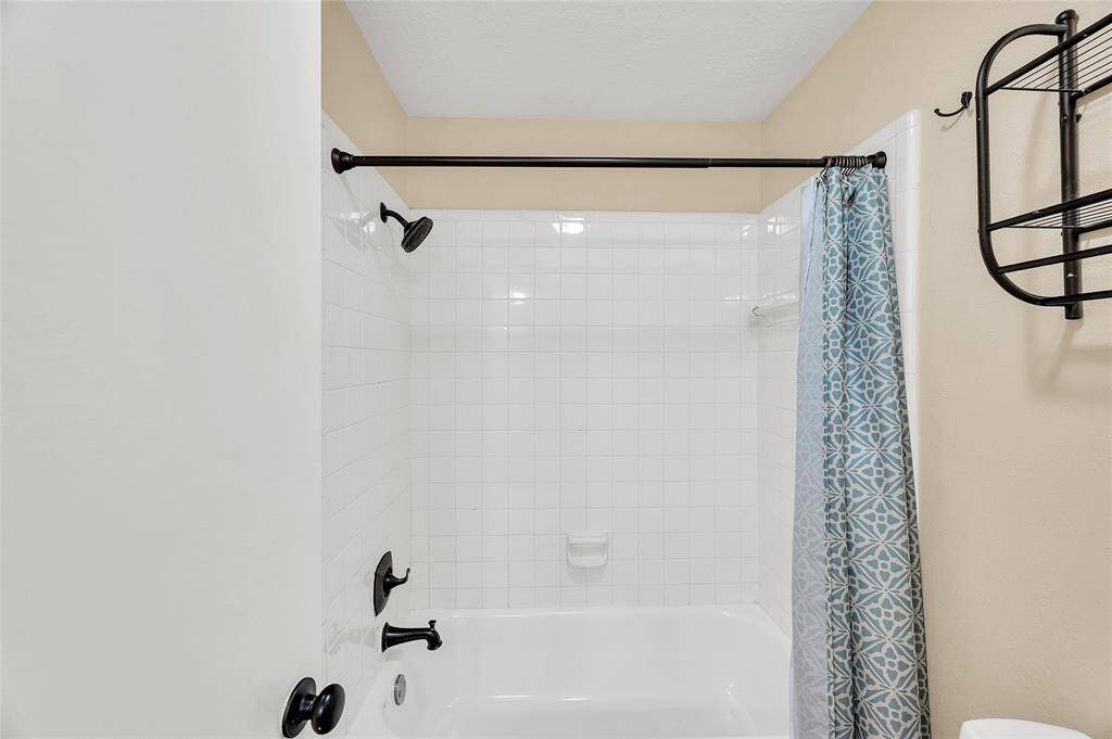 Secondary bath with tub and shower combo.
