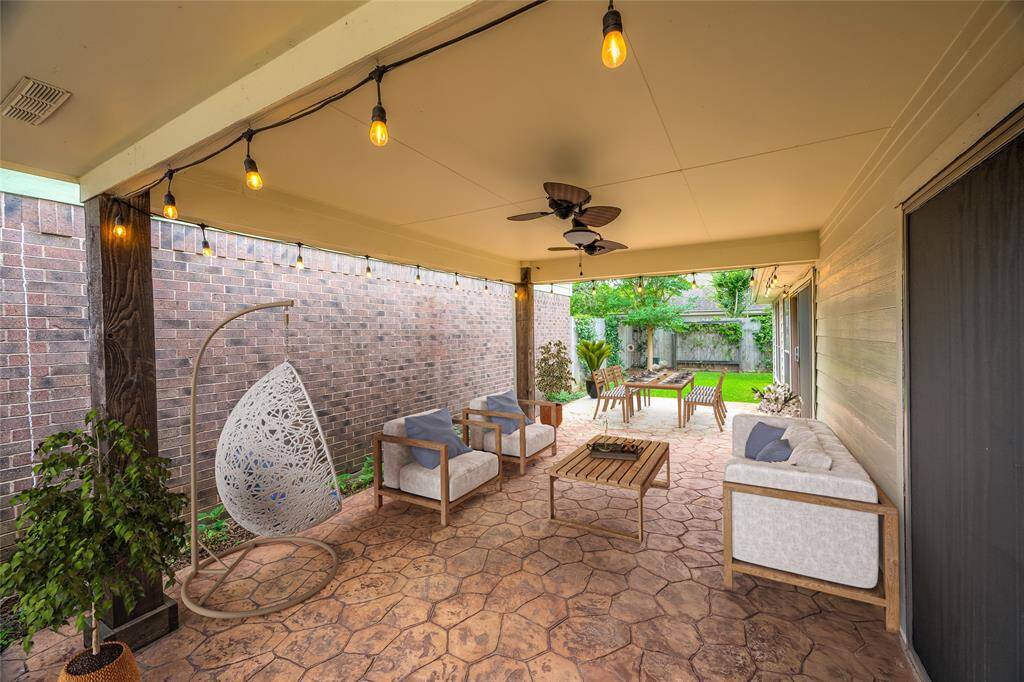 Behind the wood fence and gate is a large covered patio that feels like an outdoor room.