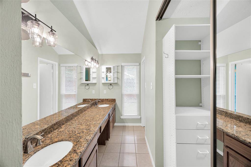 Bright and beautiful primary bath with walk-in closet, dual sinks and soaking tub.