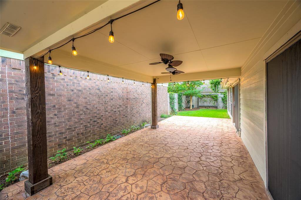 Enjoy the breeze of the ceiling fans and the view of the yard, no matter the weather.