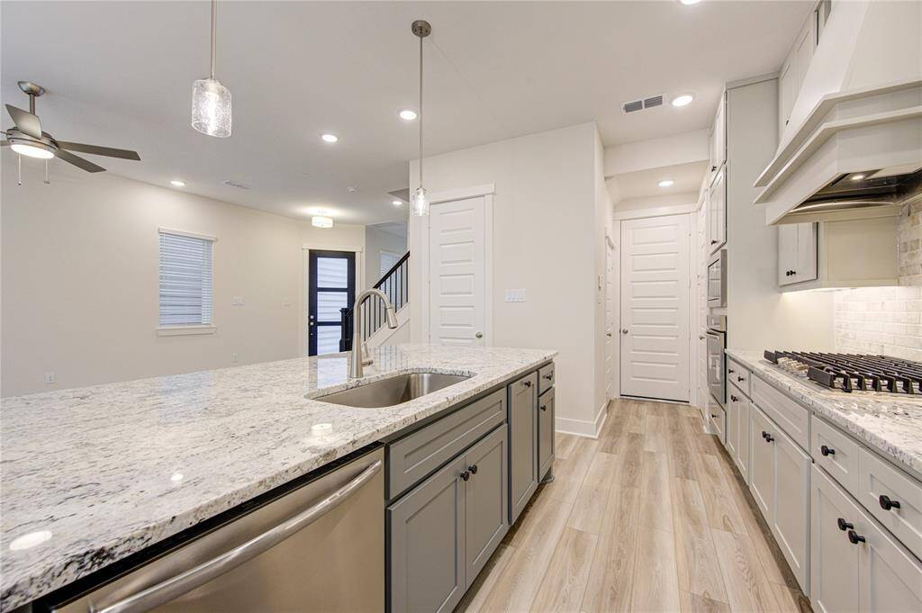 The gourmet kitchen at 16032 Mason Run is a true chef’s delight, featuring trendy finishes and all-new appliances designed for both style and function. A sleek gas cooktop allows for precision cooking, while the modern cabinetry, gleaming countertops, and large island provide ample space for meal preparation and casual dining.