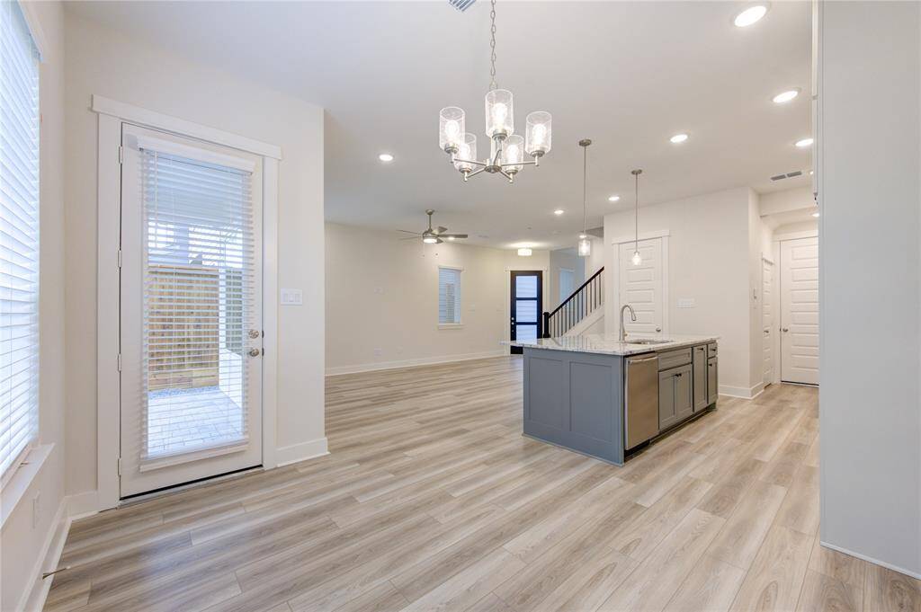 Featuring modern pendant lighting and an open flow to the kitchen, the dining area is perfect for everything from casual meals to formal dinner parties.