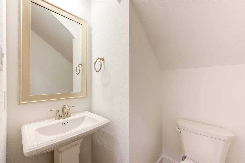 Conveniently located on the first floor, the powder room is both stylish and functional.