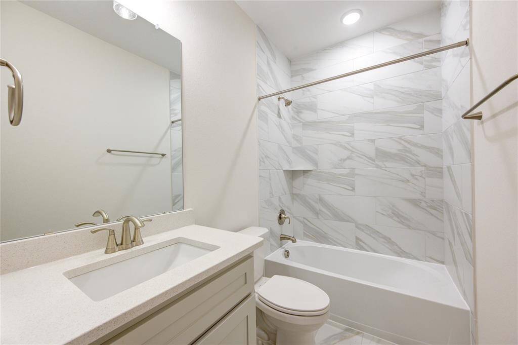 The secondary bathroom is thoughtfully designed with updated fixtures, a modern vanity, and a tub/shower combination, offering comfort and convenience for the whole family.