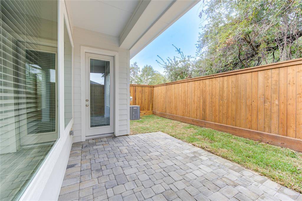 The covered patio extends your living space outdoors, providing the ideal setting for relaxing or entertaining. It overlooks the backyard and is perfect for dining, lounging, or enjoying the outdoors year-round.