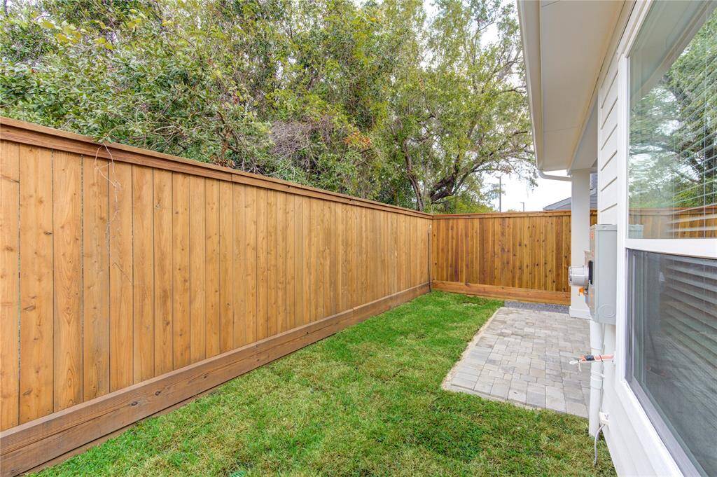 The private backyard provides ample space for outdoor enjoyment, with a well-maintained lawn perfect for gardening or play. The space offers both privacy and room for future customization.
