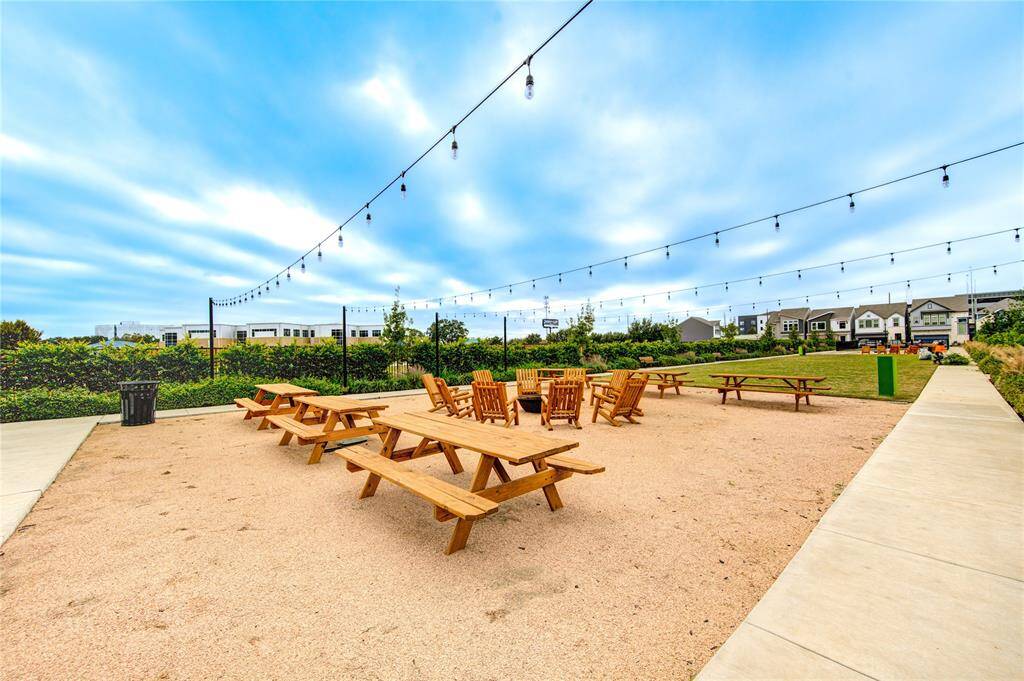 Thoughtfully designed communal spaces with seating around a fire pit, creating the perfect ambiance for evening conversations and building connections with neighbors.