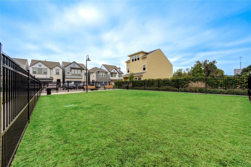 A well-maintained park featuring green spaces ideal for picnics, outdoor games, or simply enjoying a peaceful afternoon under the shade of mature trees.