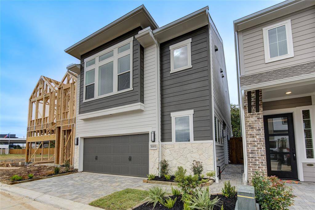 Showcasing a modern façade with clean lines, this home features a beautifully landscaped front yard and a welcoming covered porch. The driveway provides ample parking for guests.