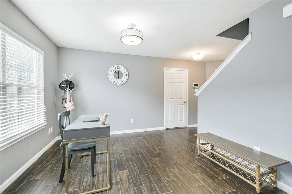 This flexible room just off the main living area is full of possibilities—perfect for a formal dining space, stylish home office, or creative nook. With natural light pouring in and wood-look tile underfoot, it’s ready to adapt to your lifestyle.