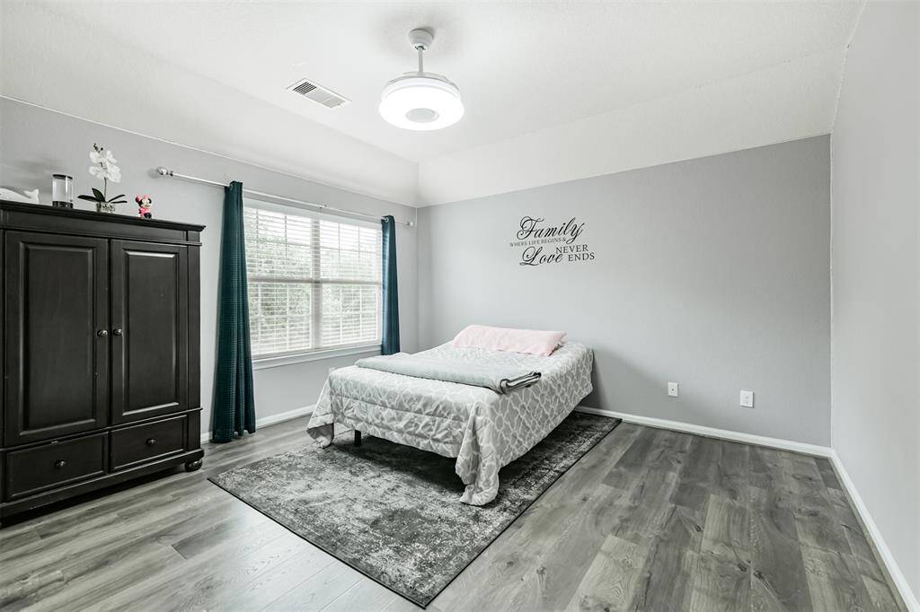 Retreat to this spacious and serene primary bedroom, featuring soft natural light, soothing tones, and elegant flooring. It’s the perfect place to unwind at the end of the day, offering comfort, privacy, and room to relax.