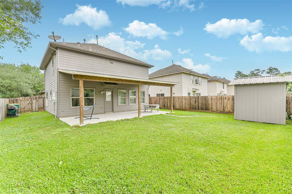 Enjoy outdoor living year-round with this spacious backyard featuring a covered patio, a handy storage shed, and a lush lawn—perfect for relaxing, entertaining, or letting pets play. There’s plenty of room to make this outdoor space your own.