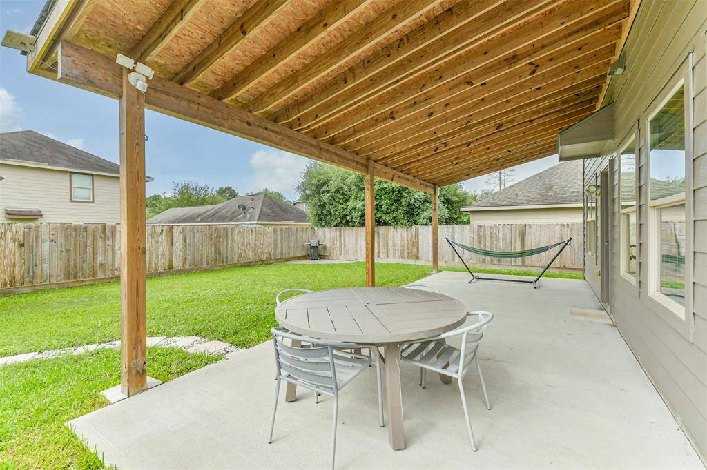Unwind or entertain with ease on the spacious covered patio—perfect for outdoor dining, grilling, or relaxing rain or shine. This backyard retreat offers the ideal blend of comfort and privacy.