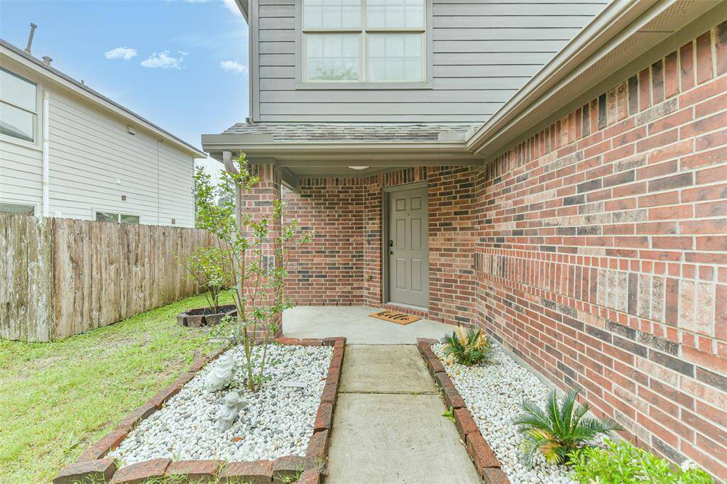 The covered front porch is perfect for welcoming guests with charm and curb appeal. The brick exterior and inviting entryway set the tone for the warmth and comfort found inside.