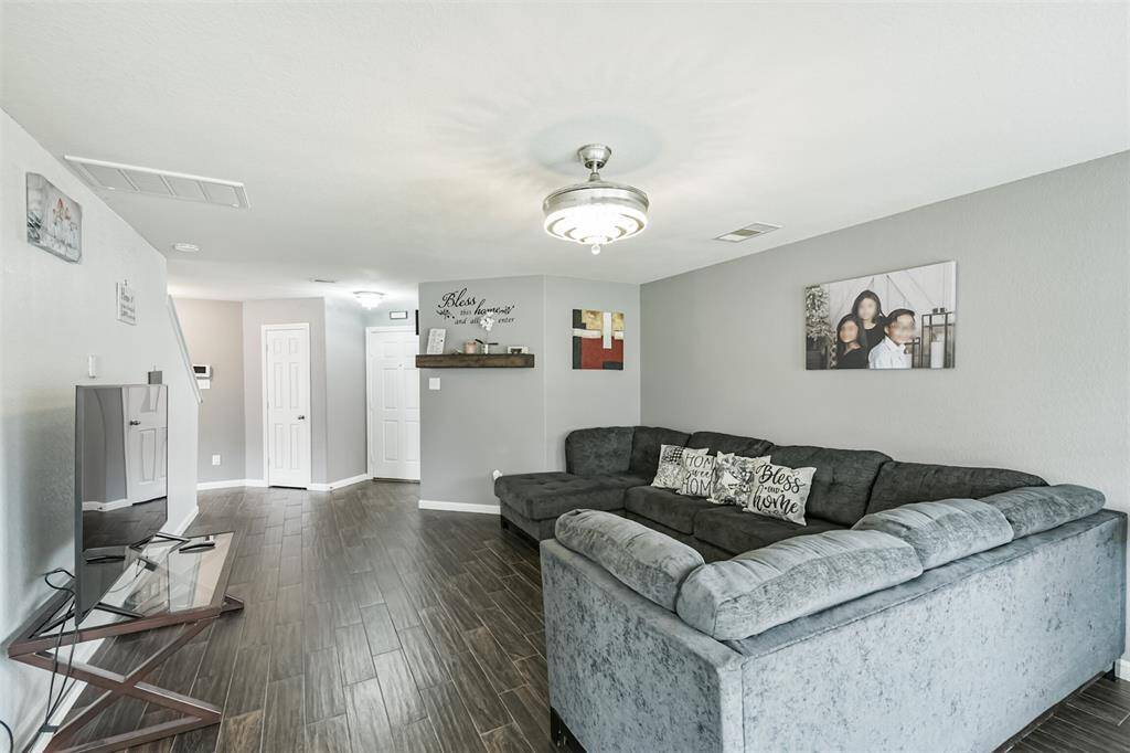 This cozy living space invites you to kick back and feel right at home. The wood-look tile flows seamlessly throughout, tying together comfort and style with a modern touch