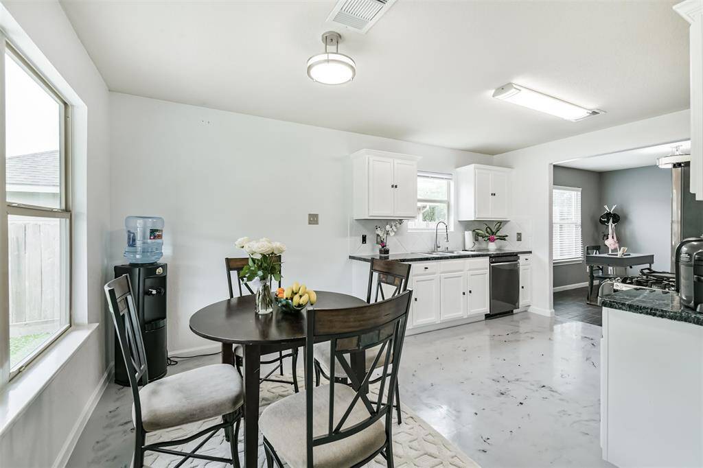 Start your day with sunshine in this bright breakfast nook, perfectly situated off the kitchen and filled with natural light. Whether it's morning coffee or a casual meal with loved ones, this inviting space offers the perfect backdrop for everyday moments.