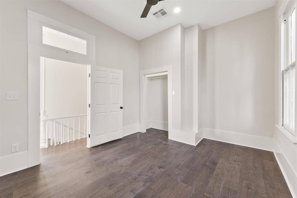 Another bright bedroom with tall ceilings, original trim, and a peaceful atmosphere.