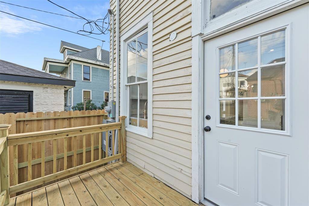 Private back entry with a brand-new wood deck and convenient access to the fenced backyard.