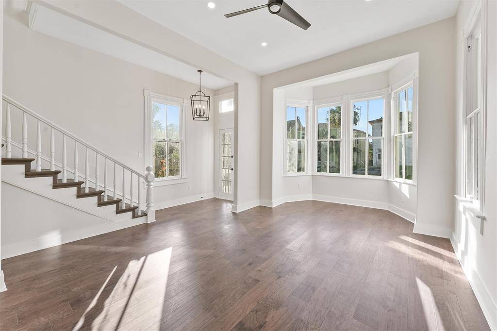Flooded with natural light, this cozy front room showcases restored original windows and beautiful bay-style architecture.