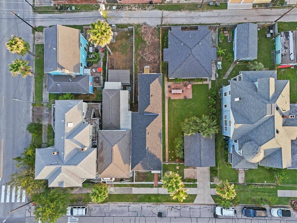 Direct overhead shot capturing lot boundaries, green space, and surrounding homes.