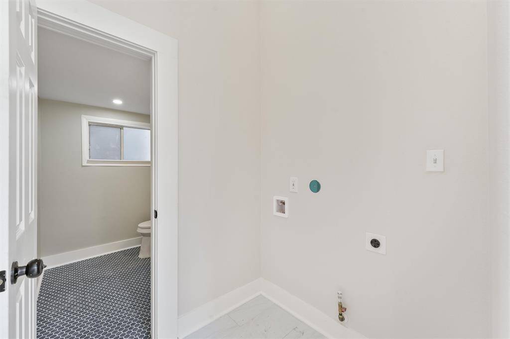 Dedicated laundry area conveniently located on the main level, right off the hallway near the powder bath.