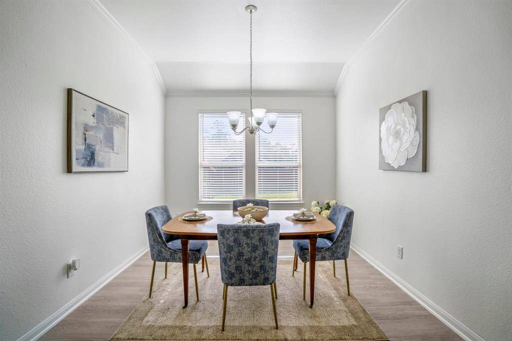 The dining area, just beyond the kitchen, offers a spacious spot for meals and entertaining. Natural light pours in, creating a bright and inviting atmosphere perfect for gatherings.