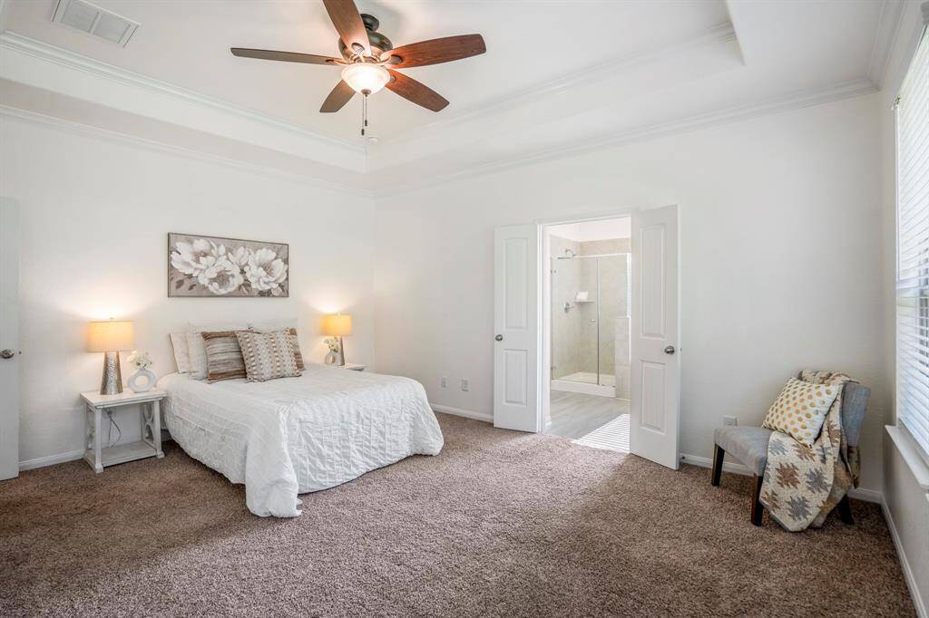 From this angle of the primary bedroom, we get a glimpse of the primary bath, just beyond, offering easy access and a private retreat for relaxation.