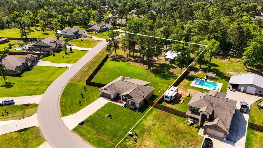 Aerial view highlights the generous 1.499-acre corner lot, offering plenty of space to spread out and enjoy the peaceful surroundings of Deer Pines.