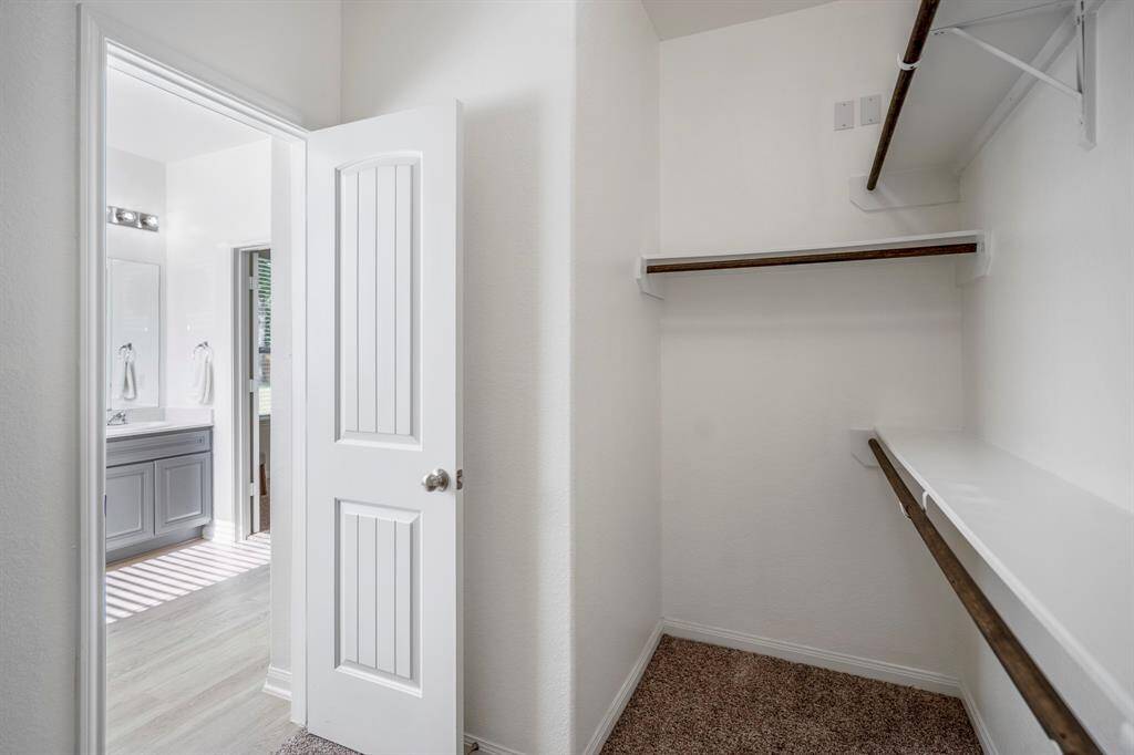 From inside the closet, you can appreciate the generous hanging space on both sides, providing ample room for all your storage needs.
