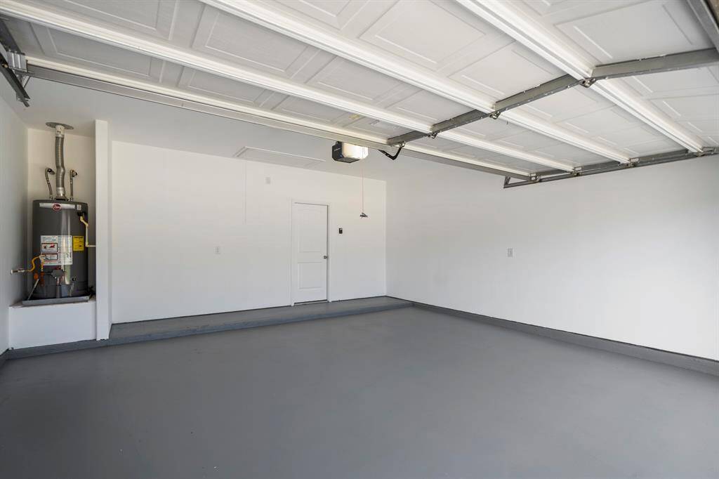A look inside the spacious 2-car garage, offering ample room for parking, storage, or a workbench setup.