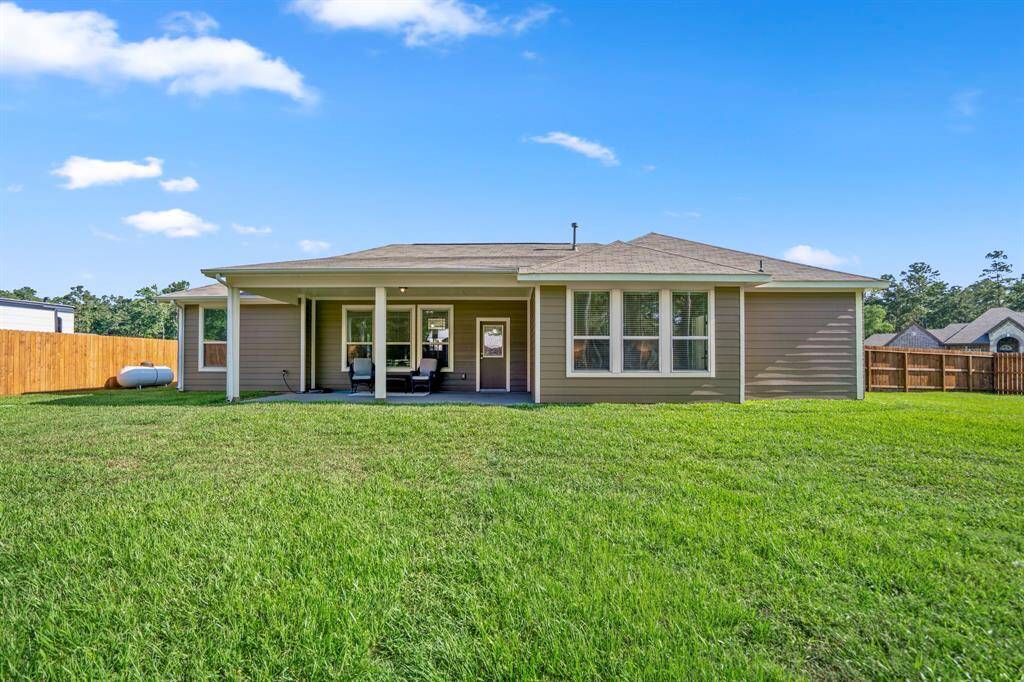 A look back towards the home highlights the lush green lawn, well-maintained with the help of an irrigation system that keeps both the front and back yards beautifully hydrated.
