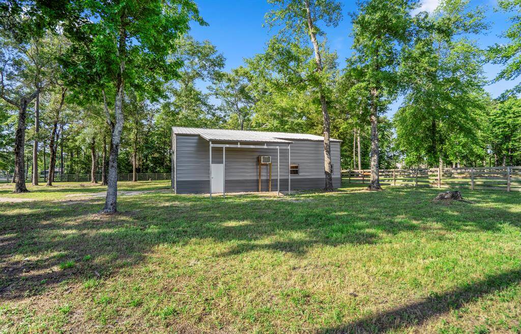 A closer view of the 30x40 metal barn reveals its sturdy construction with spray foam insulation and a concrete slab floor, providing a versatile space for storage, a workshop, or other needs.