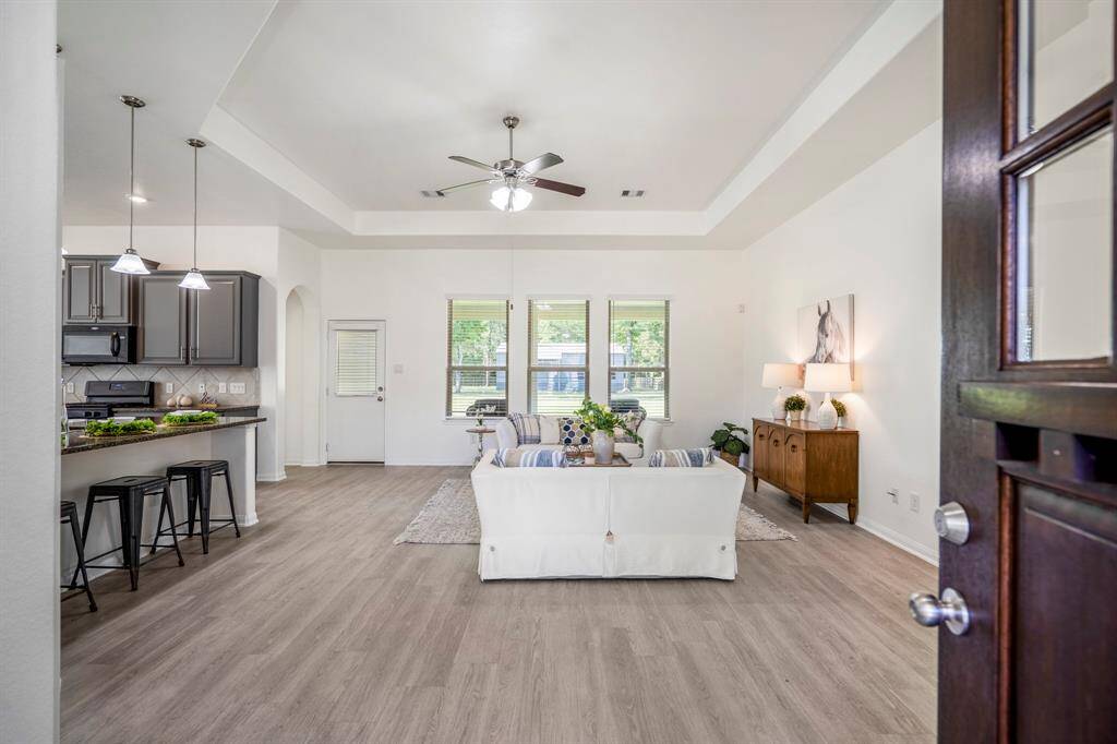 Stepping inside the front door, you're welcomed into a spacious living area where an open layout invites you to relax or entertain with ease.