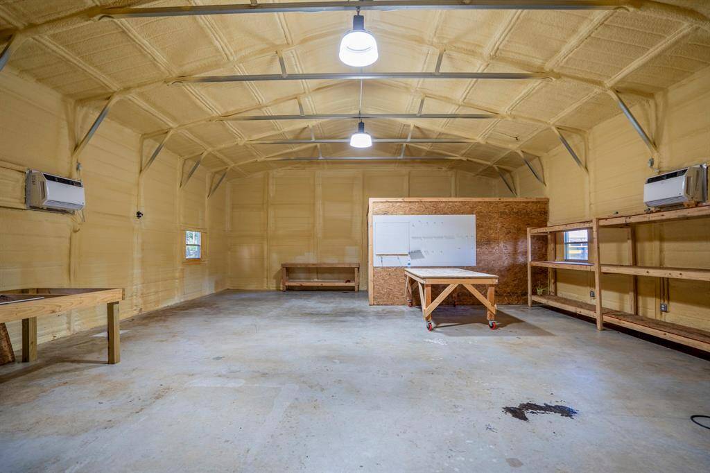 Inside the building, the open space is ready to accommodate a variety of uses, with ample room for storage, a workshop, or hobbies. The spray foam insulation keeps the space comfortable year-round, while the concrete slab floor provides a solid foundation for any project.