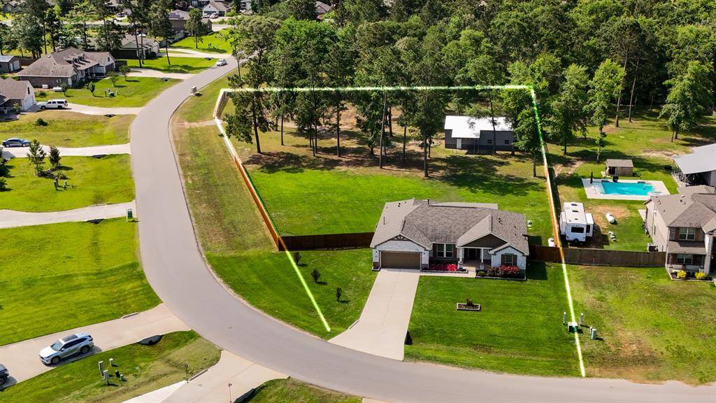 From this aerial view above the street, we get a clear sense of the home's corner placement and how the lot stretches out around it. The estimated lot lines help paint the picture of just how much space surrounds this country retreat.