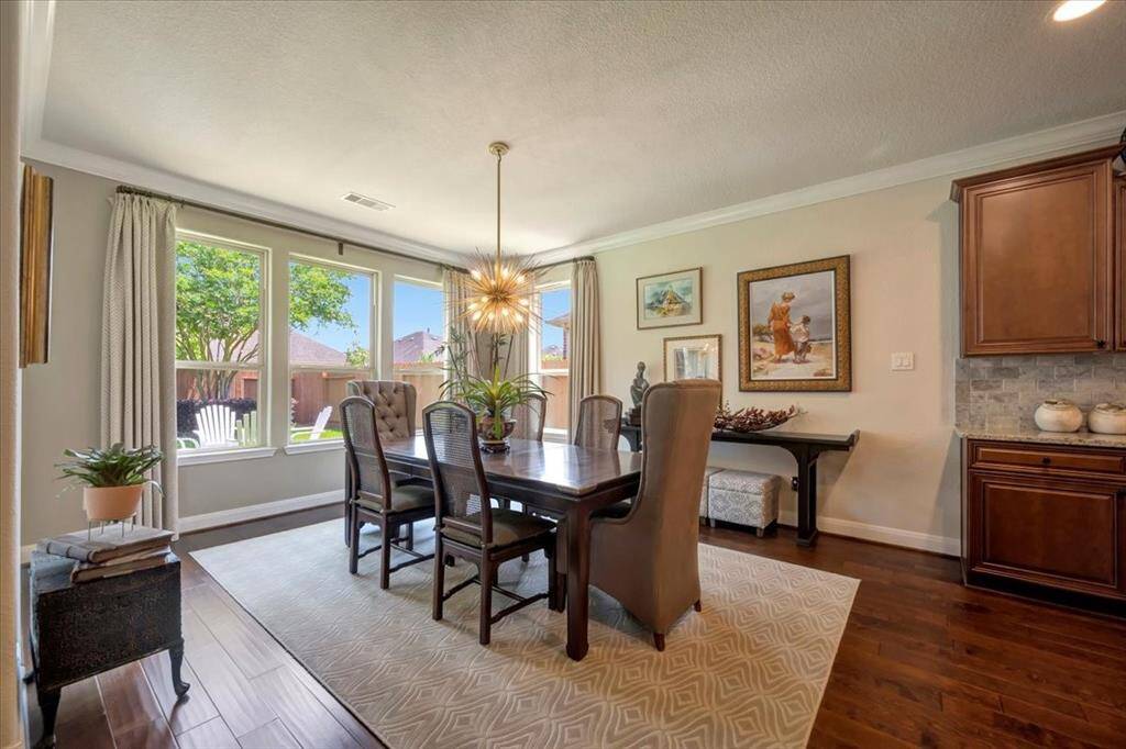 The space offers a seamless transition to the kitchen, making it ideal for both intimate dinners and festive gatherings.