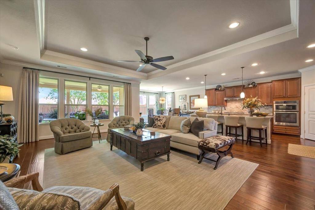 Wow! Trayed ceilings, rich flooring with crown molding are part of much of the home.