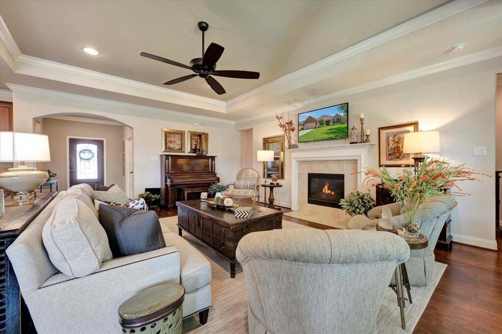 Anchored by a cozy fireplace, the open-concept layout is ideal for entertaining and everyday living.