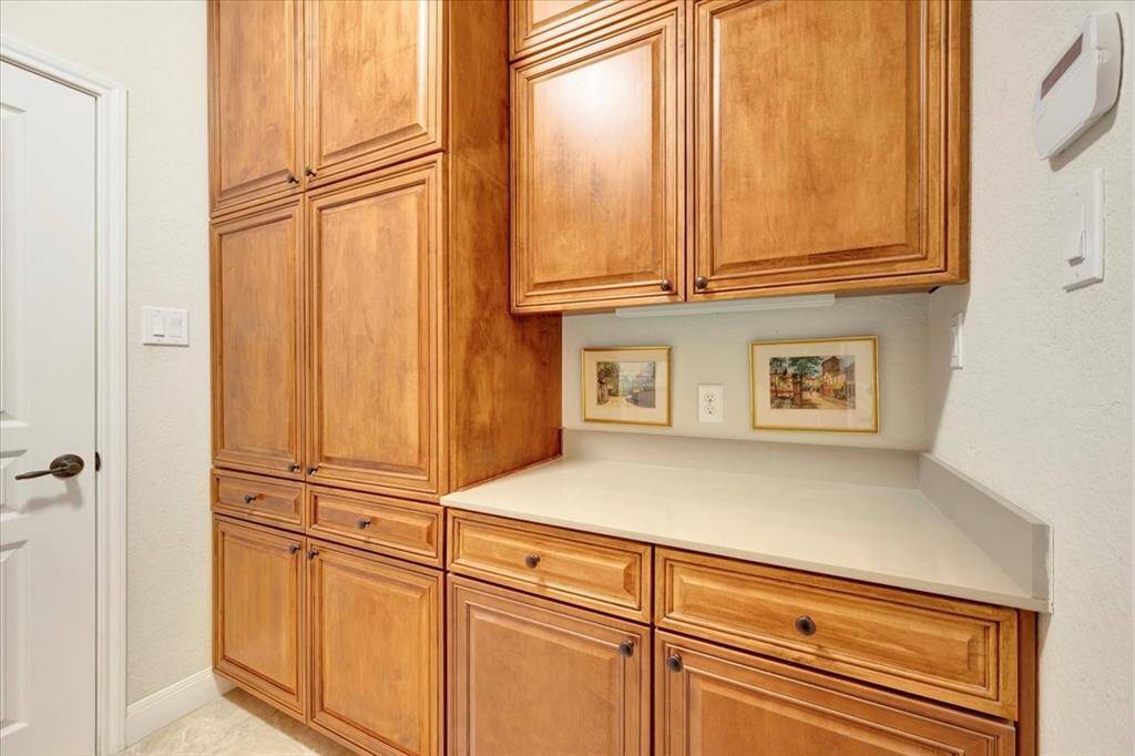 The custom built-in cabinets offer plenty of room to organize your essentials.