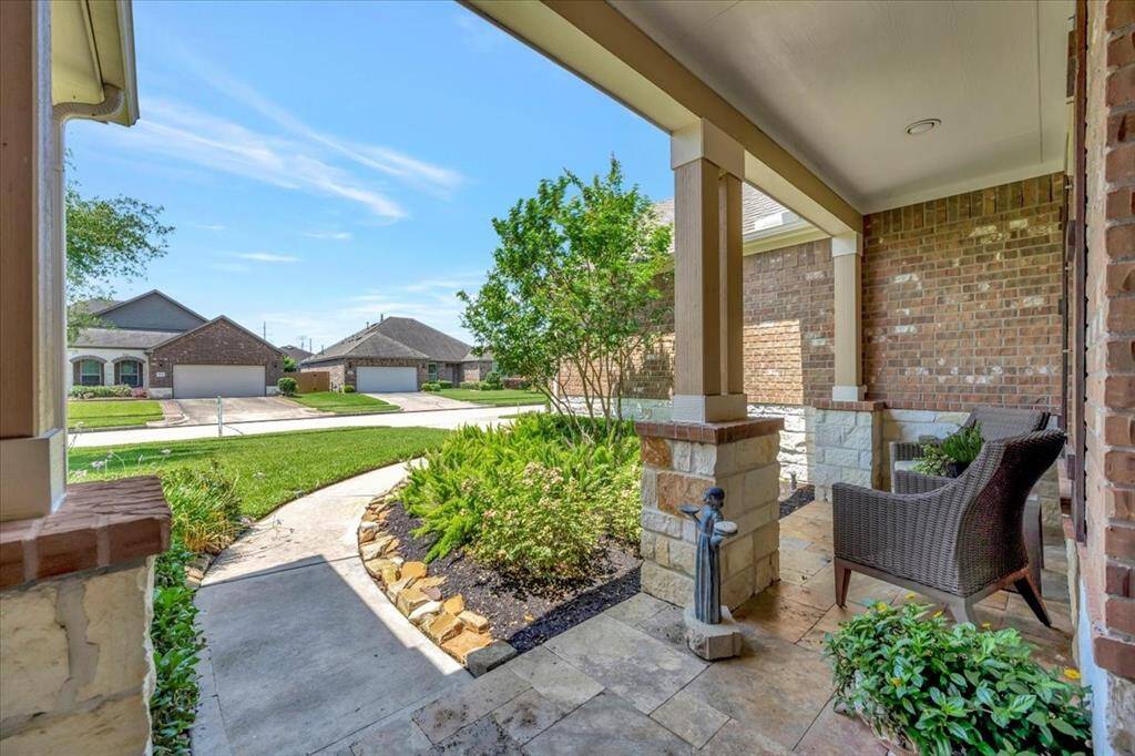 Inviting entryway framed by stone and greenery – a true "welcome home" moment every time you pull into the driveway.