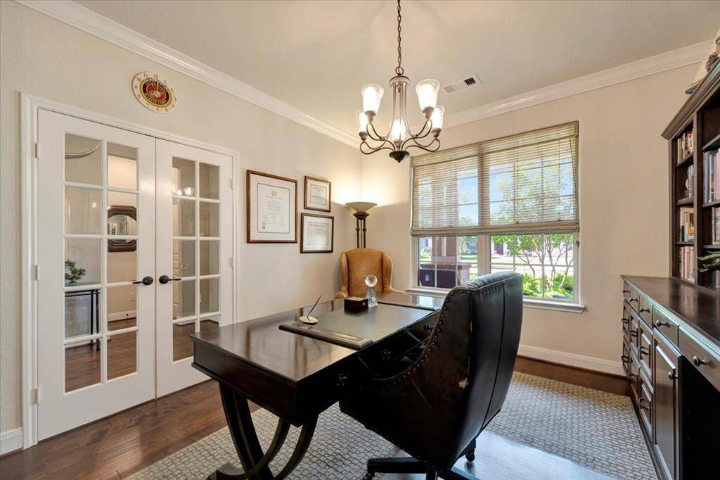 The study features double French doors that enhance the room’s elegance and create a quiet, functional workspace.
