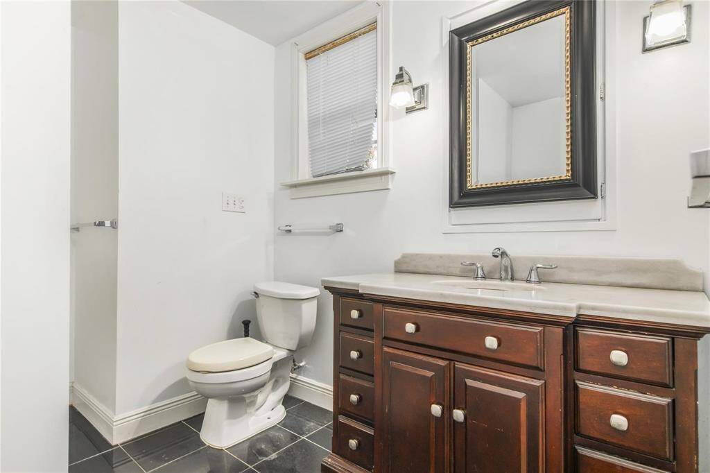 Elegant bathroom on the main level of the duplex, featuring a stylish vanity, modern fixtures, and ample lighting.