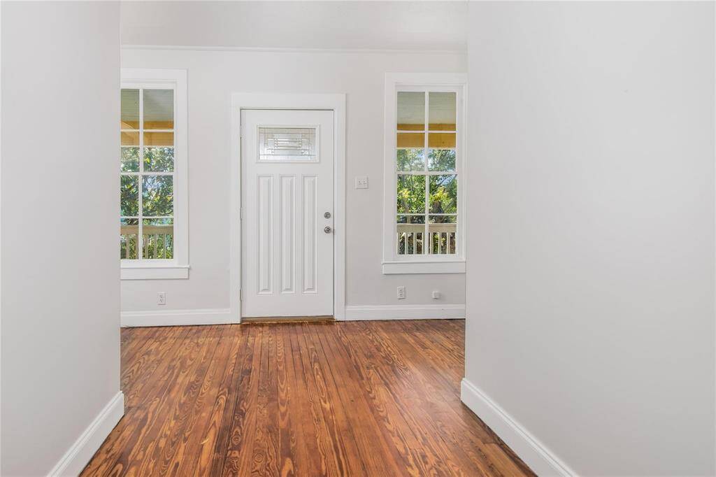 Inviting upper duplex entry with rich hardwood floors and abundant natural light.