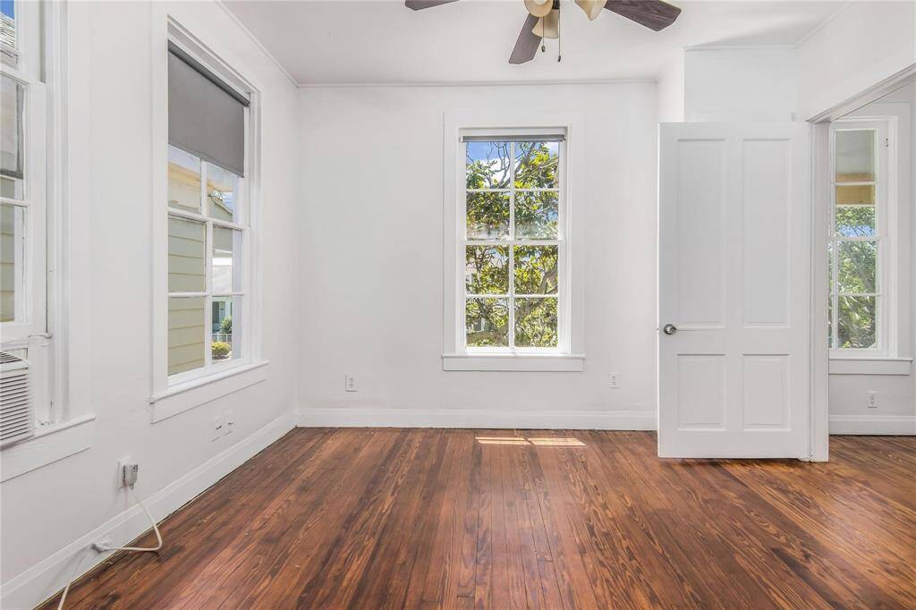 This second bedroom features beautiful hardwood floors and abundant natural light.