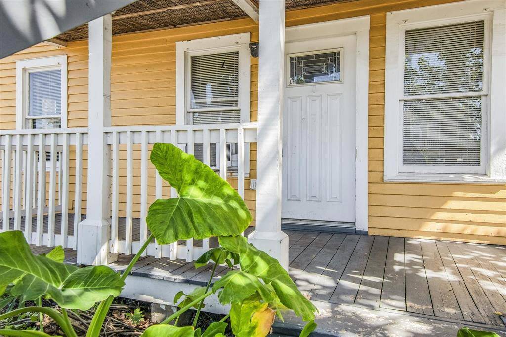 Charming duplex with inviting front porch, perfect for relaxing and enjoying the outdoors.