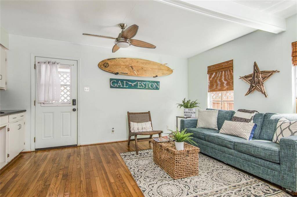Spacious cottage-style living area with charming decor and abundant natural light.