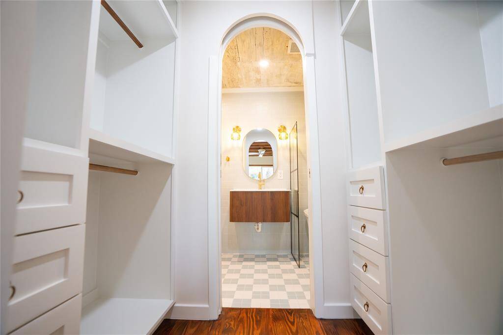 Beautiful en-suite primary bathroom with a walking closet and custom built-ins.